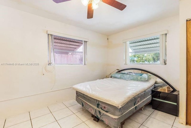 tiled bedroom with ceiling fan