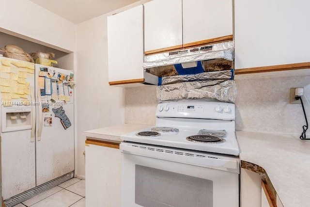 kitchen featuring light tile patterned flooring, white appliances, and white cabinets