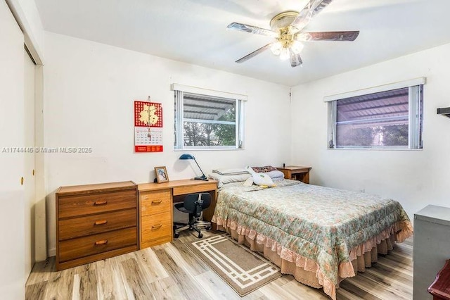 bedroom with a closet, ceiling fan, and light hardwood / wood-style flooring