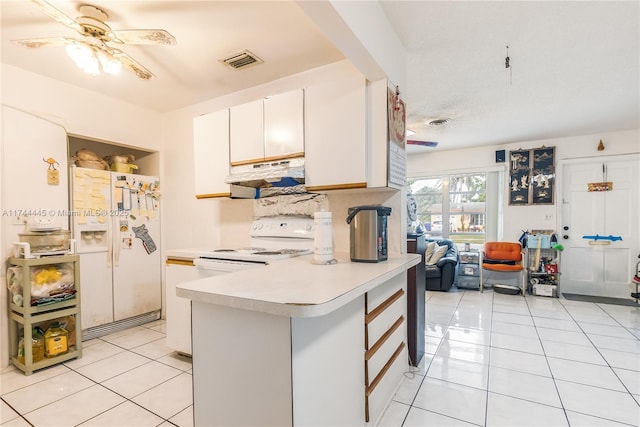 kitchen featuring white cabinetry, white refrigerator with ice dispenser, light tile patterned flooring, and kitchen peninsula