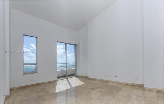 empty room featuring crown molding and a water view