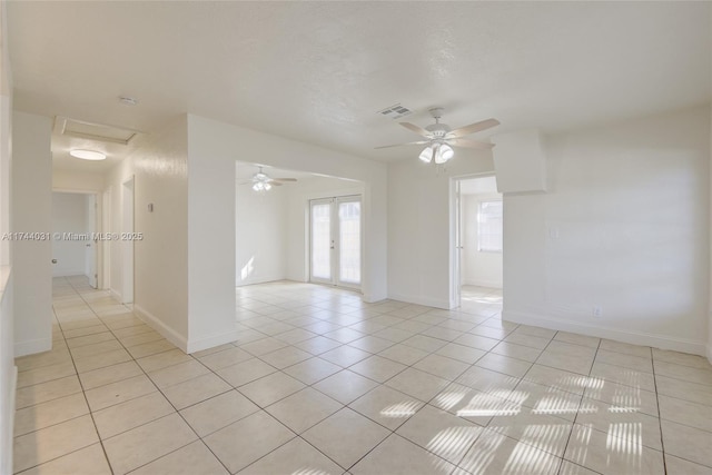 tiled spare room with french doors, ceiling fan, and a textured ceiling