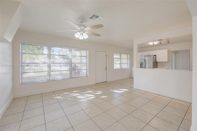 spare room with light tile patterned floors and ceiling fan