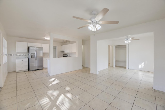 spare room with light tile patterned floors and ceiling fan