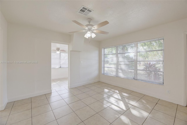 tiled spare room featuring ceiling fan and a textured ceiling