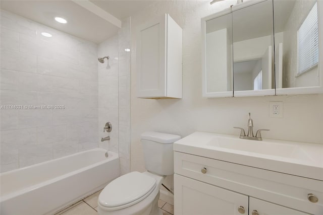 full bathroom with vanity, tile patterned flooring, tiled shower / bath combo, and toilet