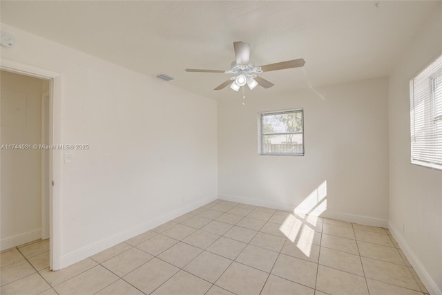 empty room featuring light tile patterned floors and ceiling fan