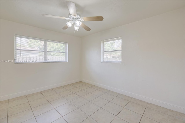 spare room featuring ceiling fan and a wealth of natural light