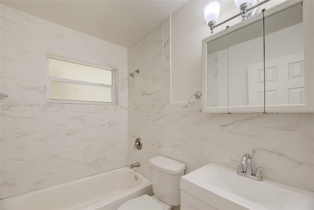 full bathroom featuring tile walls, backsplash, tiled shower / bath combo, vanity, and toilet