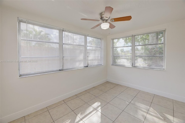 unfurnished room with light tile patterned floors and ceiling fan