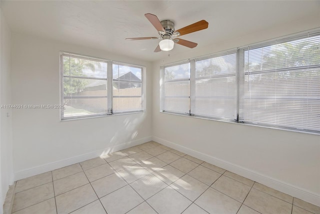 spare room with light tile patterned flooring and ceiling fan