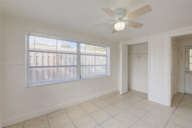 unfurnished bedroom featuring light tile patterned flooring, ceiling fan, and a closet