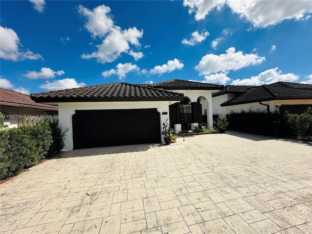 mediterranean / spanish-style house featuring a garage