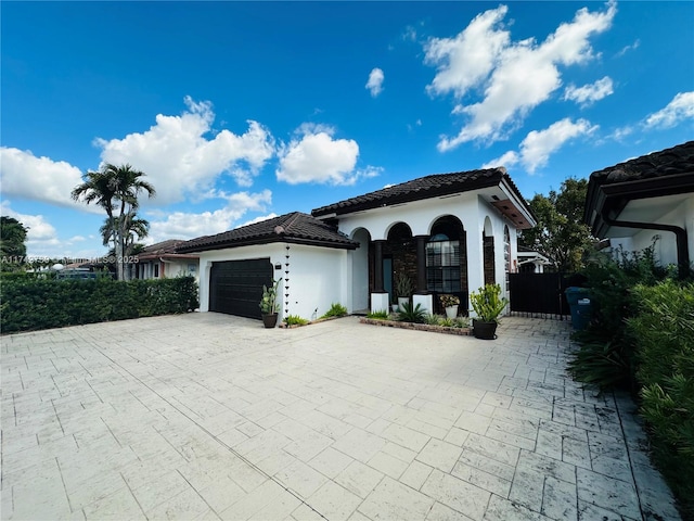 mediterranean / spanish house with a garage