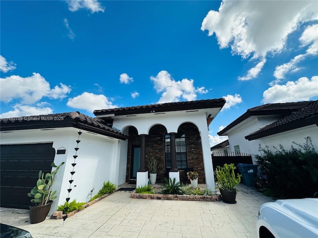 mediterranean / spanish-style home featuring a garage