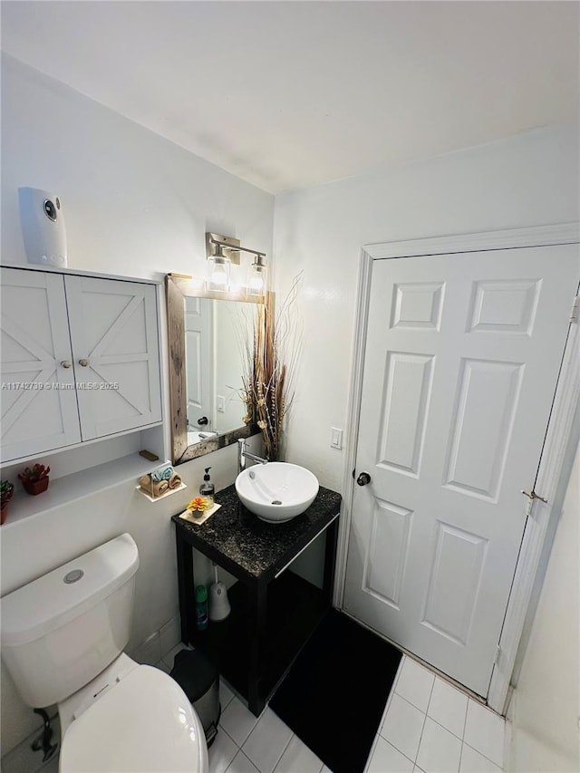 bathroom featuring vanity, toilet, and tile patterned floors