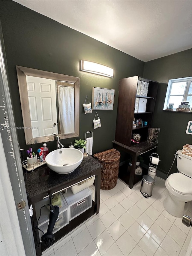 bathroom with vanity, toilet, and tile patterned floors