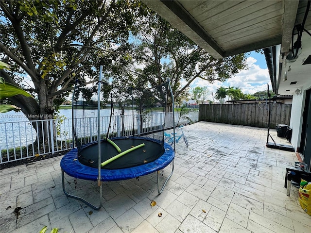 view of patio / terrace featuring a water view and a trampoline