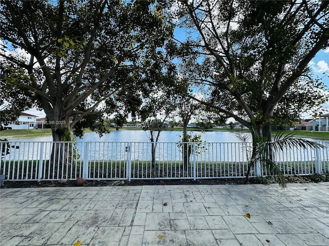 view of gate with a water view