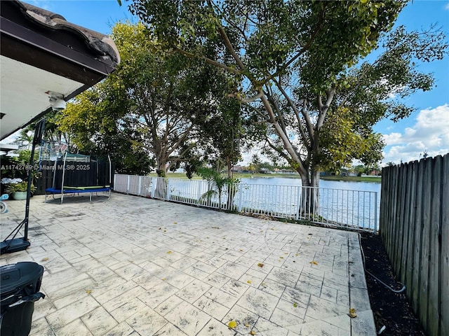 view of patio / terrace with a trampoline and a water view