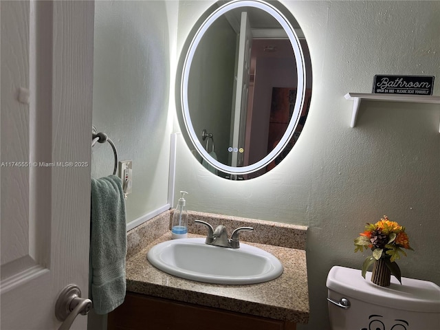 bathroom featuring vanity and toilet