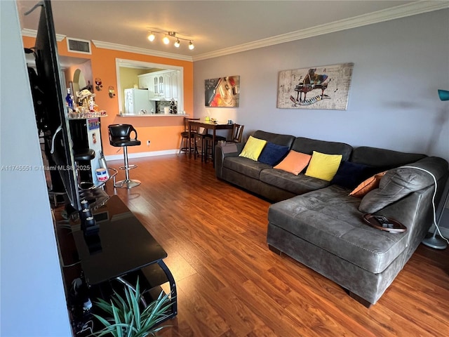 living room with hardwood / wood-style floors and ornamental molding