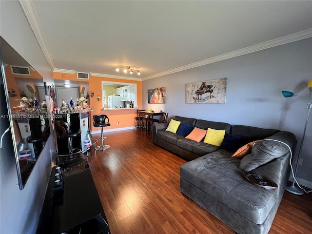 living room with hardwood / wood-style flooring and crown molding