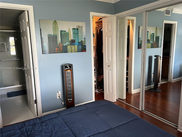 unfurnished bedroom with dark hardwood / wood-style flooring and a closet