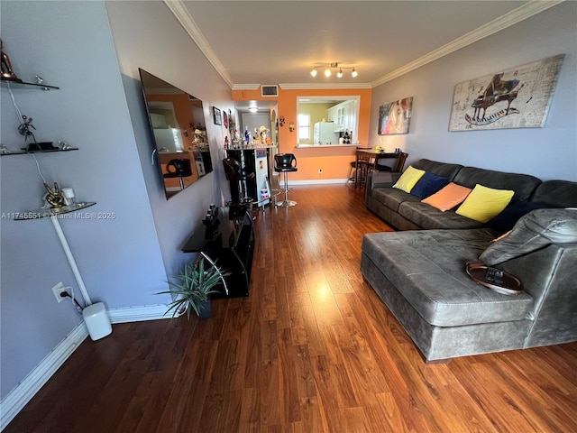 living room featuring ornamental molding and wood-type flooring