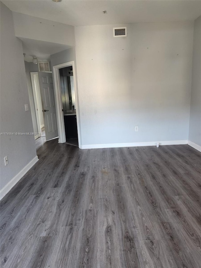 unfurnished room featuring dark hardwood / wood-style flooring