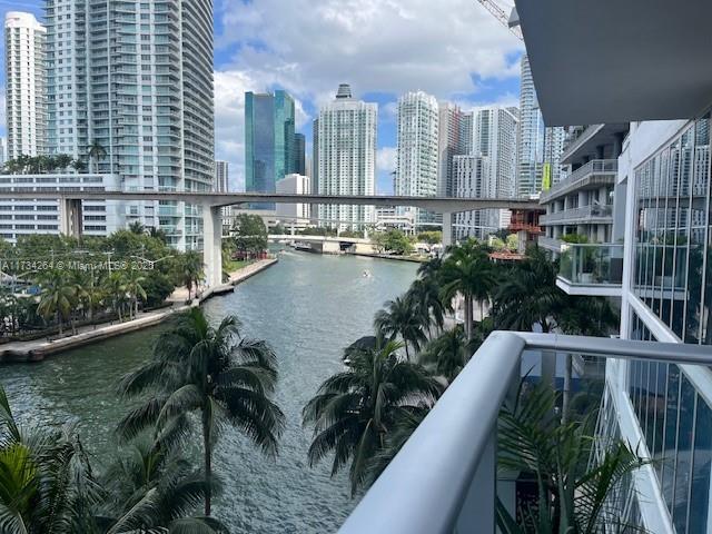 balcony featuring a water view and a view of city