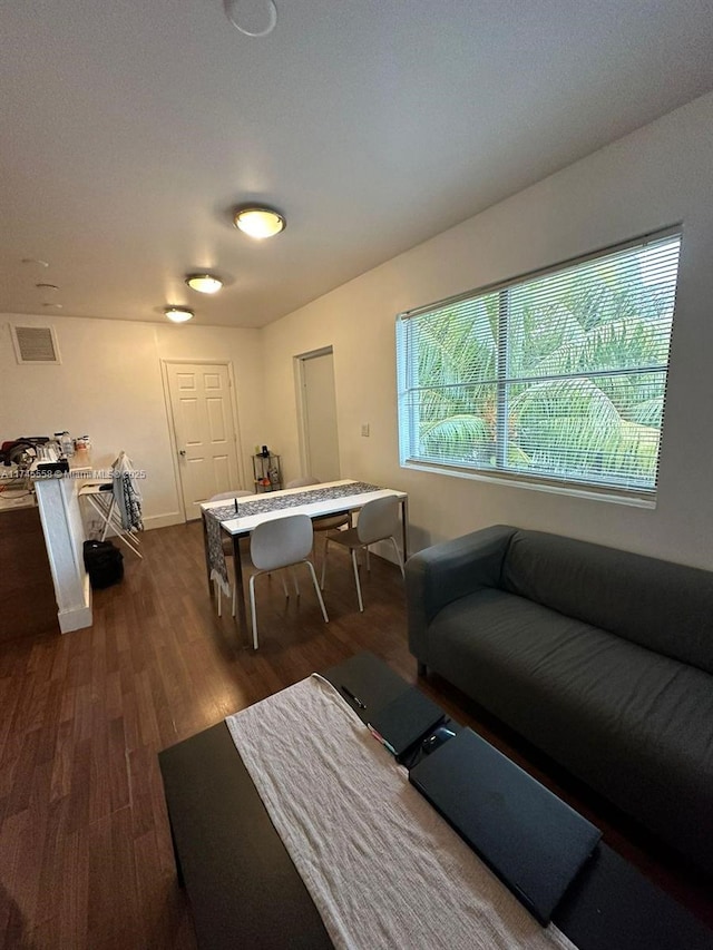 rec room featuring baseboards, visible vents, and dark wood-type flooring