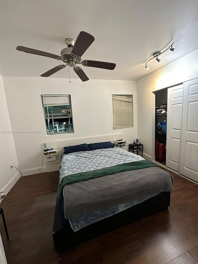 bedroom with a closet, baseboards, and wood finished floors