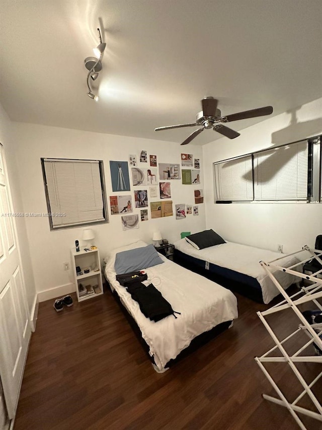 bedroom with baseboards, a ceiling fan, and wood finished floors