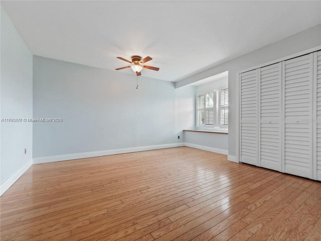 unfurnished bedroom featuring light hardwood / wood-style floors, a closet, and ceiling fan