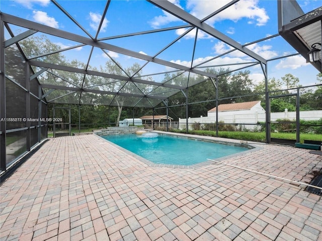 view of swimming pool with a patio area and glass enclosure