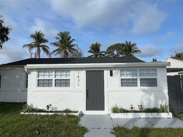 ranch-style home featuring stucco siding