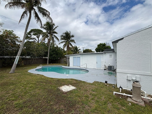 view of swimming pool with a fenced in pool, a patio, a fenced backyard, cooling unit, and a yard