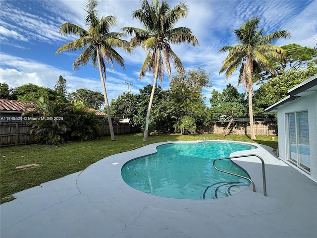 view of pool with a fenced in pool, a fenced backyard, a lawn, and a patio