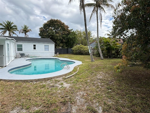 view of swimming pool featuring a fenced in pool, a yard, fence, and a patio