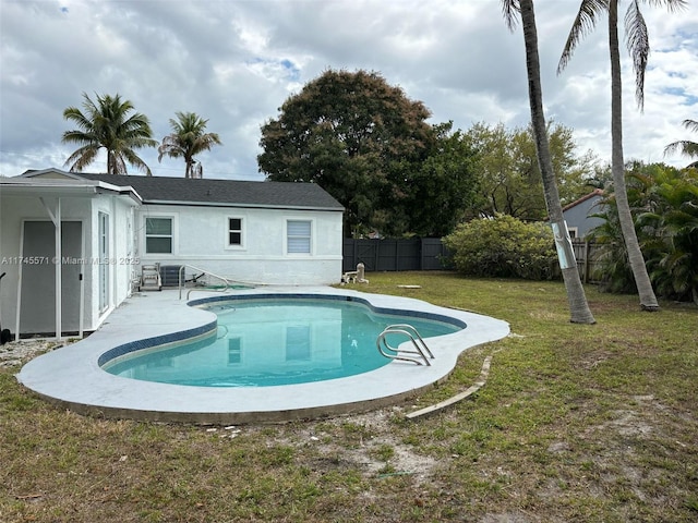 view of pool featuring a patio, fence, a fenced in pool, and a yard