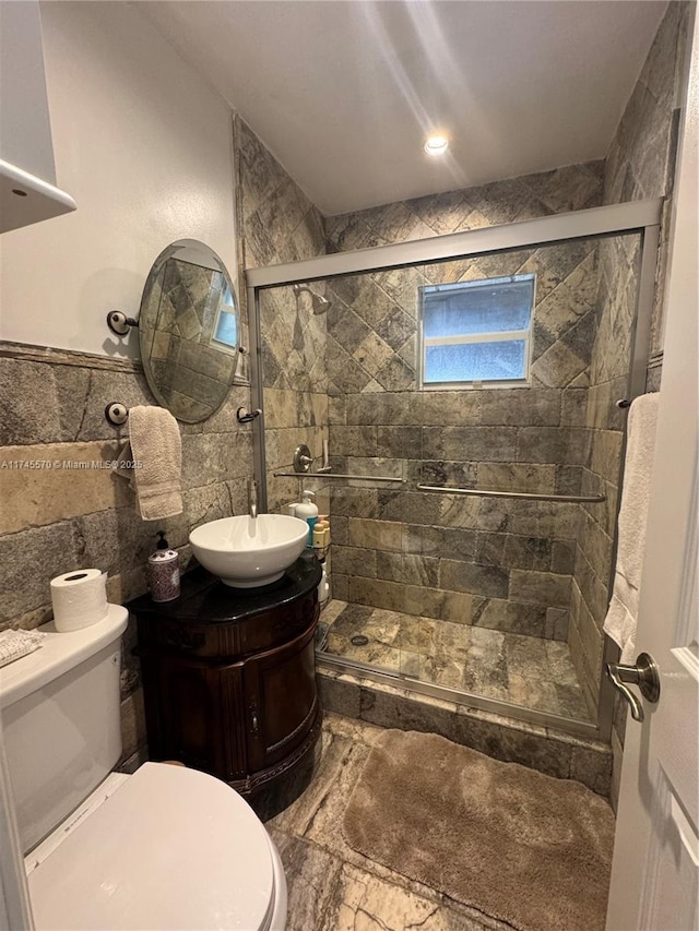 1787 NE 174th St, North Miami Beach, FL 33162 - full bath featuring vanity, a wainscoted wall, a stall shower, tile walls, and toilet
