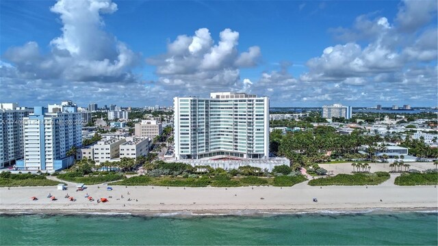 birds eye view of property featuring a water view and a view of the beach