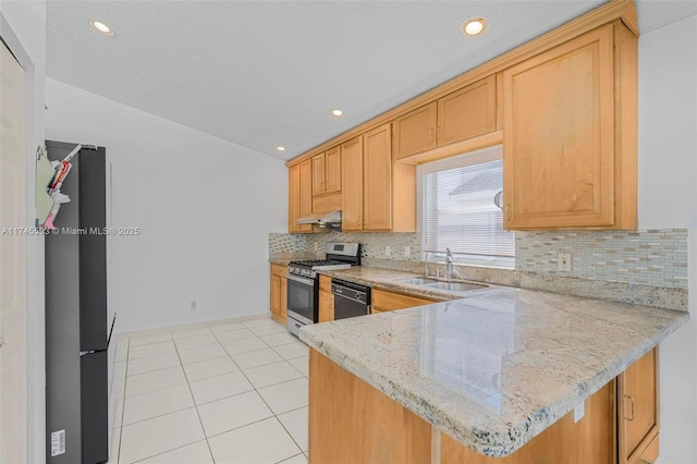 kitchen with black dishwasher, fridge, light tile patterned floors, kitchen peninsula, and gas range