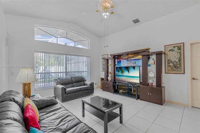 living room featuring lofted ceiling, light tile patterned floors, a textured ceiling, and ceiling fan