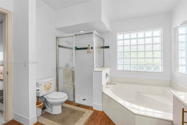 bathroom featuring independent shower and bath, hardwood / wood-style floors, and toilet