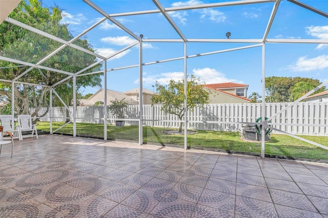 view of patio featuring glass enclosure