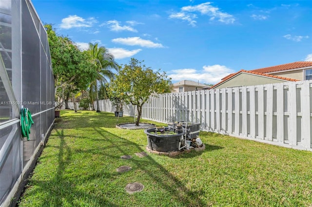 view of yard featuring glass enclosure