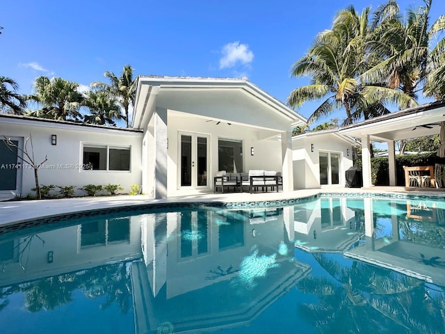 rear view of property featuring french doors and outdoor lounge area