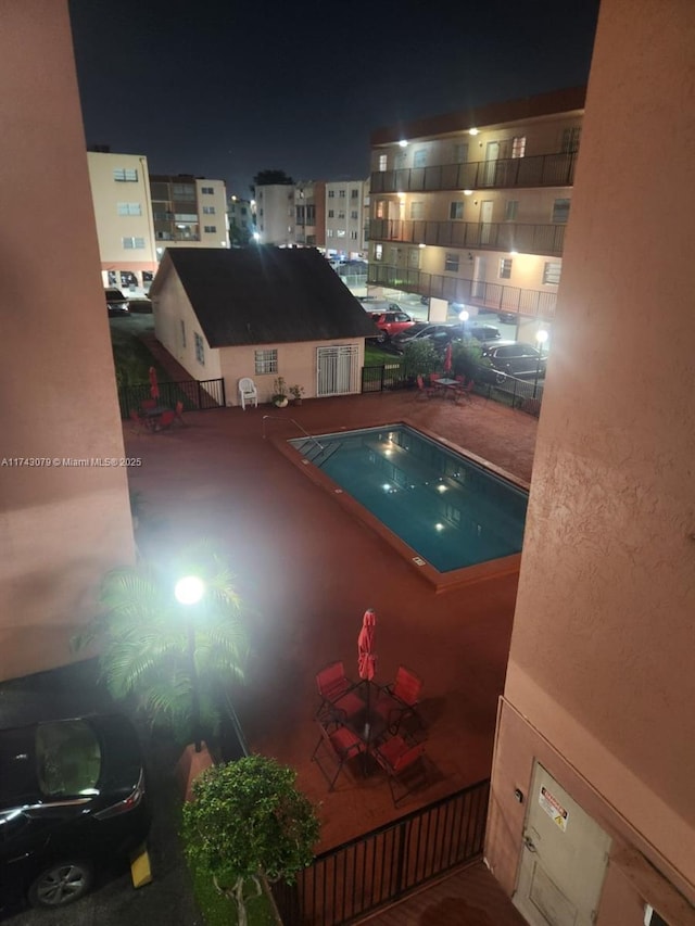 pool at twilight featuring a patio